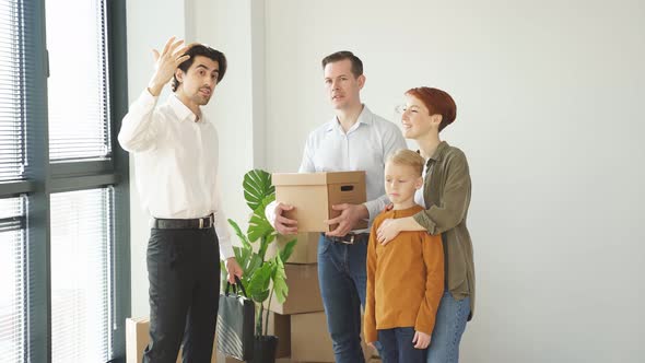 Caucasian Real Estate Agent In Formal Wear Representing New House To Customers