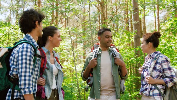 Friends with Backpacks Hiking and Making High Five