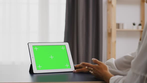 Woman Using Tablet Computer with Green Screen