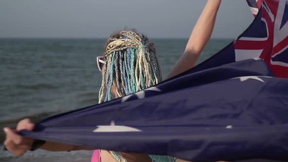 Attractive Woman in a Swimsuit on the Sea Beach with the Flag of Australia Closeup