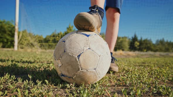 Football player with the ball on the football field near the gate