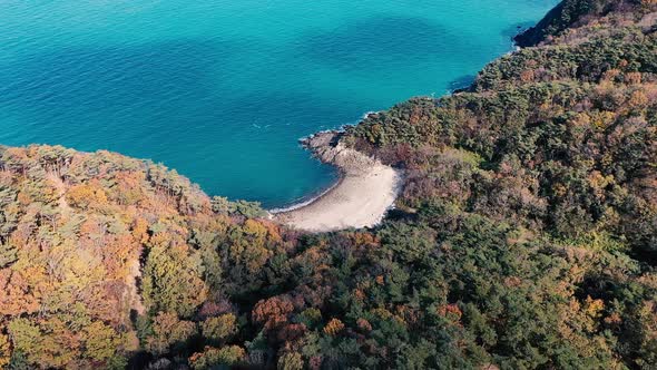 Drone flying over forest and islands.