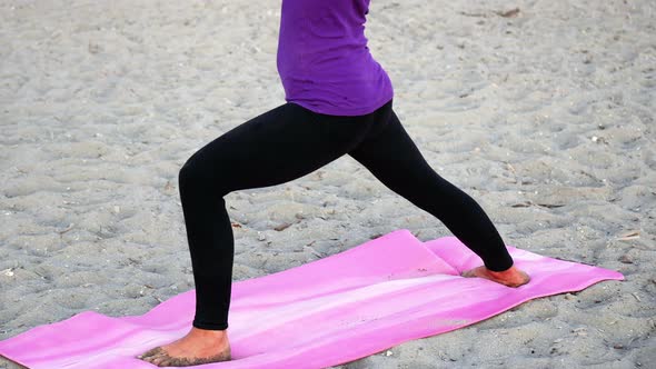 Woman performing stretching exercise on the beach