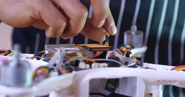 Male Hands are Repairing a Drone