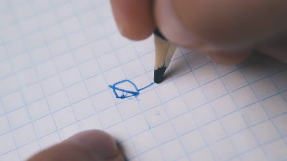 Man Draws Image Breaking Blue Pencil on Paper Macro