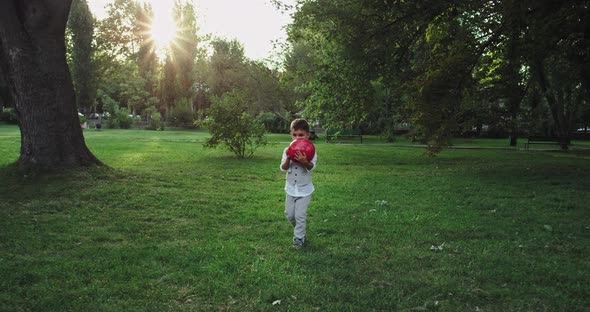 Good Looking Pretty Small Boy with a Red Ball