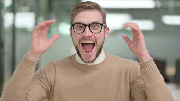 Excited Young Creative Man Celebrating Success