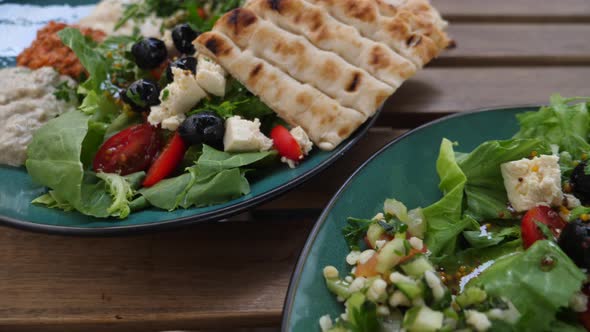 Top View of Two Plates with Meze, Salads Dips and Pita. Healthy Organic Middle Eastern Cuisine 