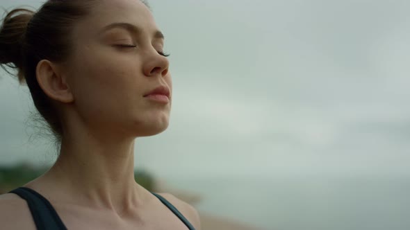 Yogi Woman Making Deep Breath Meditating on Beach