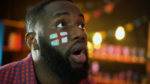 Black Male With English Flag Painted on Cheek Disappointed Football Team Failure