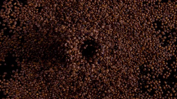 Roasted Coffee Beans Milling in Electric Grinder with Open Cover Close Up