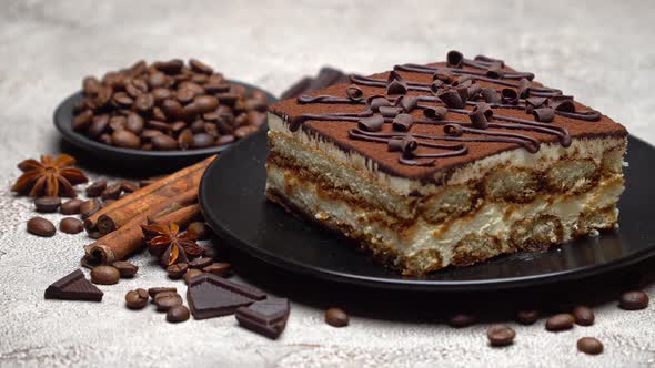 Portion of Traditional Italian Tiramisu dessert and coffee beans