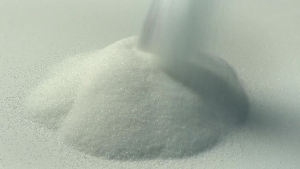Sugar Pours Onto White Surface