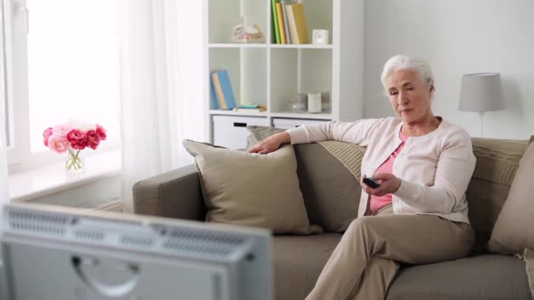 Happy Senior Woman Watching Tv at Home