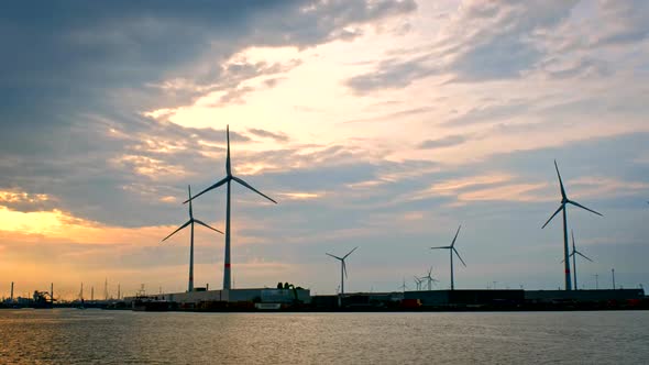 Wind Turbines in Antwerp Port on Sunset.