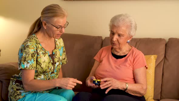 Measurement of the pulse on elderly woman. Placed on the finger heart rate monitor.