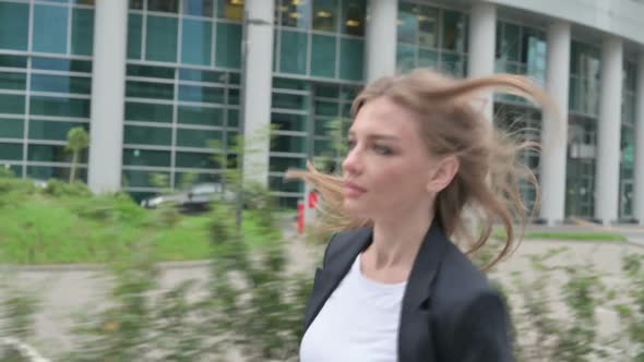 Businesswoman Running in Street in Slow Motion Side Pose