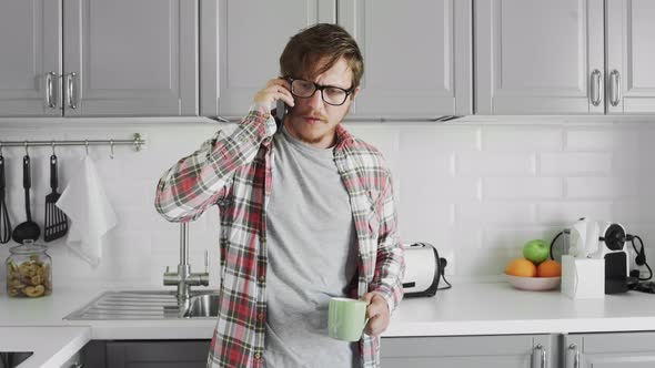 Young Man Talking on the Phone at Home