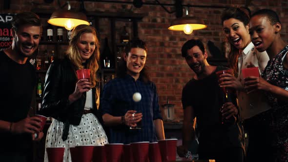 Friends playing with ball in bar