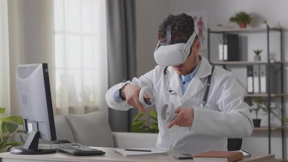 Man Doctor Working in Hospital Office Using Virtual Reality Technology