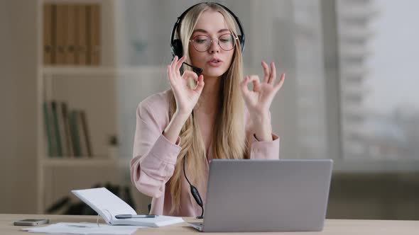Millennial Business Woman Online Distant Mentor in Headset Talking Looking to Camera Showing