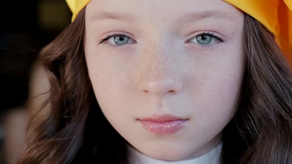 Beautiful little girl in a yellow hat. Shooting close up