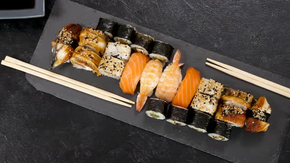 Variety Mix of Traditional Sushi Rolls on Black Stone Plate