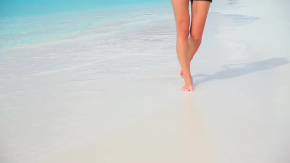 Woman walking on the beach. Full HD Video
