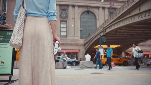 Young girl with a retro camera at the Grand Central Terminal in New York