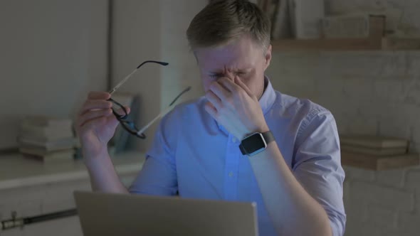 Businessman Having Headache While Working on Laptop