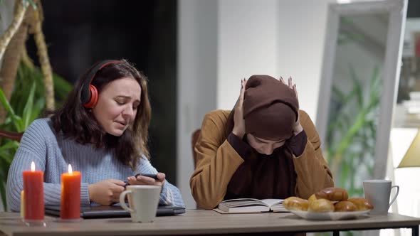 Medium Shot of Joyful Caucasian Millennial Woman Listening to Music in Headphones Singing As