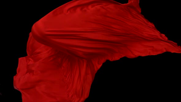 Red fabric flowing on black background, Slow Motion