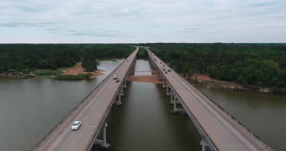 Aerial of cars driving on bridge that crosses over the San Jacinto River in Houston, Texas