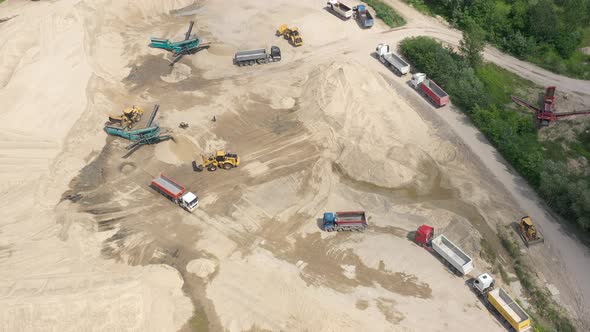 Mining conveyor at sand quarry. Aerial view of mining machinery. Mining industry