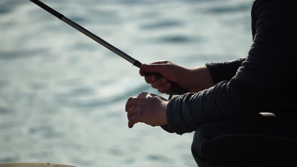 Man Hobby Fishing on Sea Tightens a Fishing Line Reel of Fish Summer