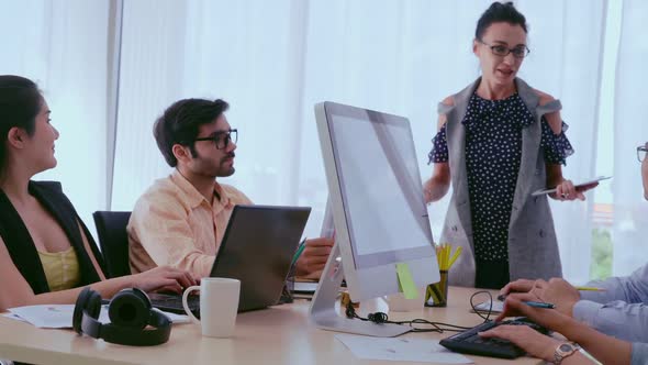 Creative Business People Group Having Conversation at Office Desk in Workplace