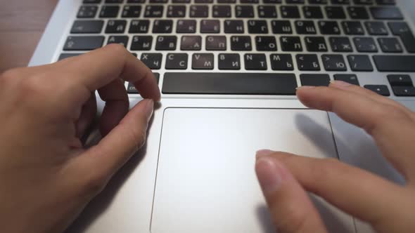 Closeup of Young Caucasian Woman's Hand on Laptop Work with Touchpad