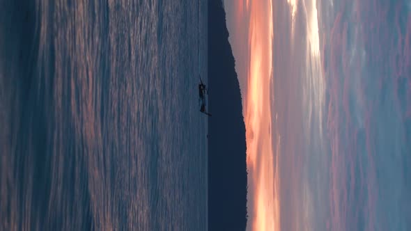 Long-tail boat sailing during sunset, Phuket Thailand. VERTICAL video