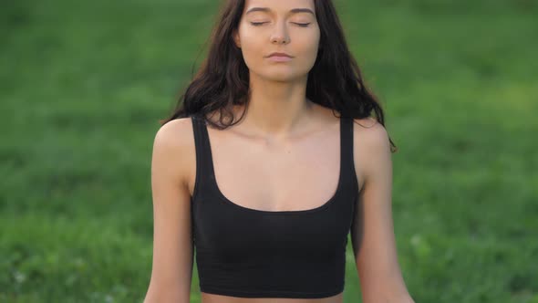 Woman Practicing Yoga Outdoors in Park