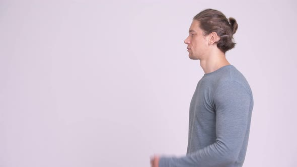 Profile View of Handsome Man Thinking Against White Background