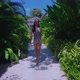 Pretty Girl In Swimming Suit Walking Alone In Resort On Sunny Day in Slow Motion - VideoHive Item for Sale