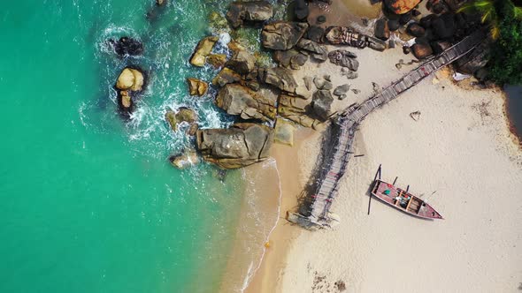 Tropical birds eye clean view of a white sandy paradise beach and blue ocean background in 4K