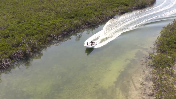 Drone Aerial View of Speedboat Sailing in Mangrove Cay, Bahamas, Tropical Water and Scenic Landscape