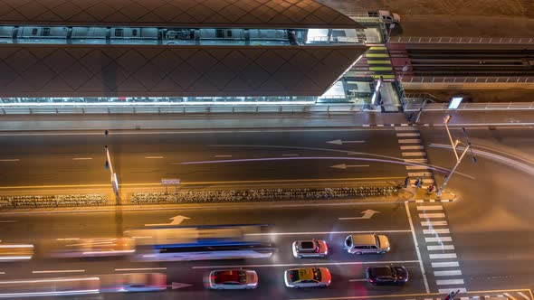 Intersection with Cars and Tram Stop with Railway Aerial View From Above Night Timelapse in Dubai