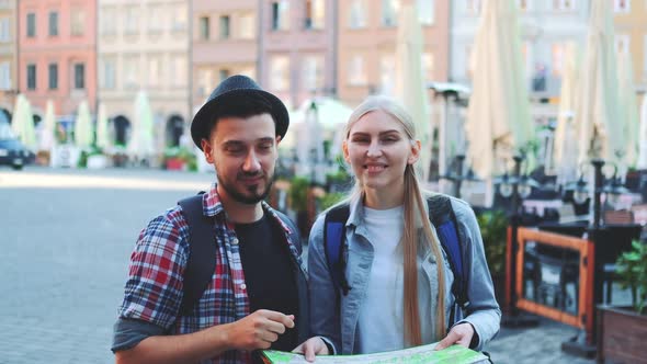 Tourists Checking Map and Then Smiling to the Camera