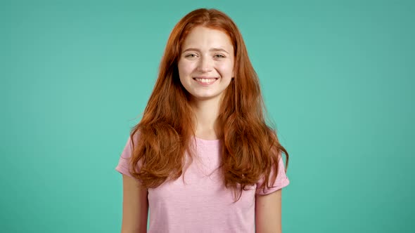 Portrait of Satisfied Girl in Pink T-shirt Showing Yes Sign By Head. Teen Permits, Treats