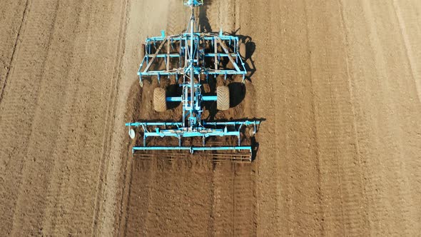 Tractor with Disc Harrows on the Farmland