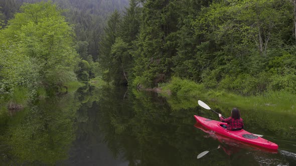 Adventure Caucasian Adult Woman Kayaking in Red Kayak