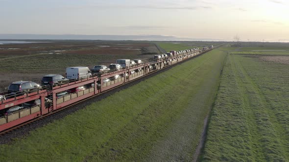 Moto Rail Train Carrying Vehicles and Passengers on a Journey