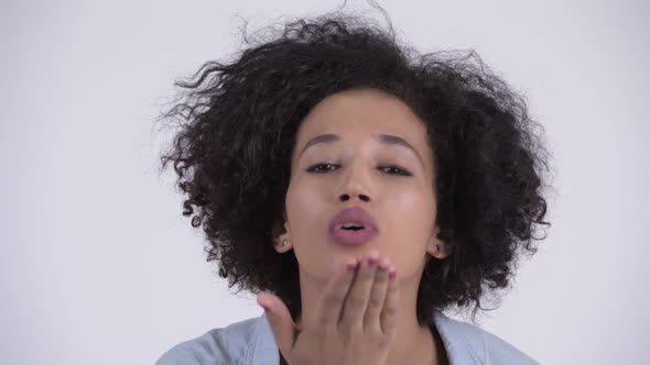 Face of Young Beautiful African Woman Blowing Kiss